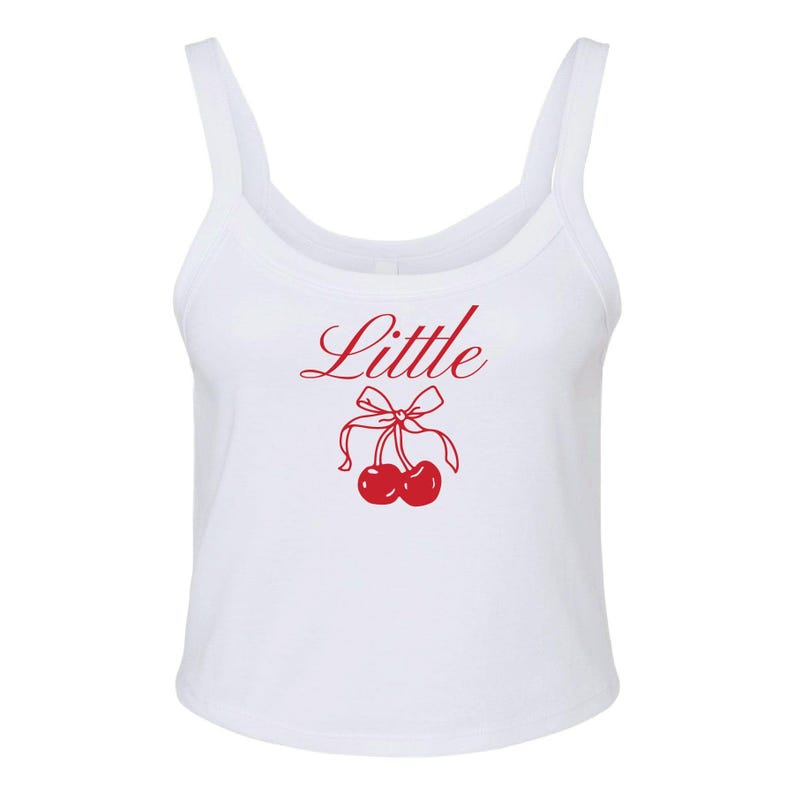 May include: White tank top with a red cherry graphic and the word "Little" in red cursive.