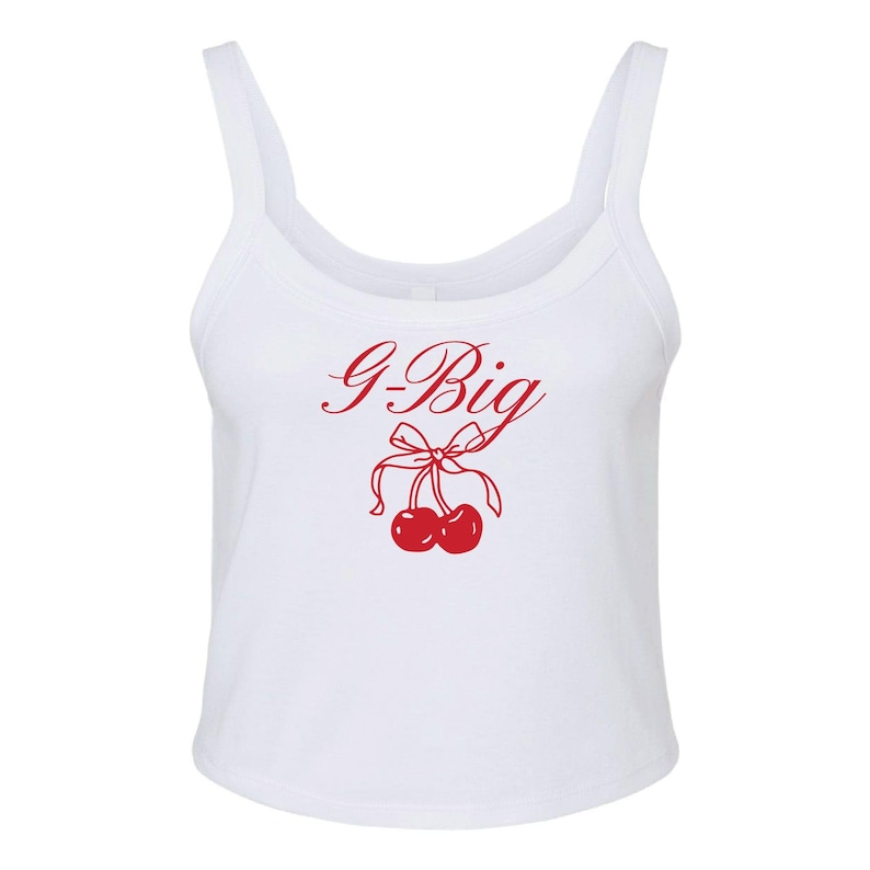 May include: White tank top with a red graphic of two cherries with a bow and the text "G-Big".