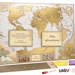 May include: A large world map with a gold foil overlay featuring a white background and black text. The map includes two rectangular text boxes with the phrases Dear Ms Au Young and Our adventures, a storage tube, a scratch tool, and push pins.