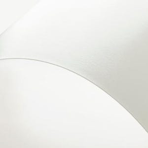 a close up of a white wall with a clock on it