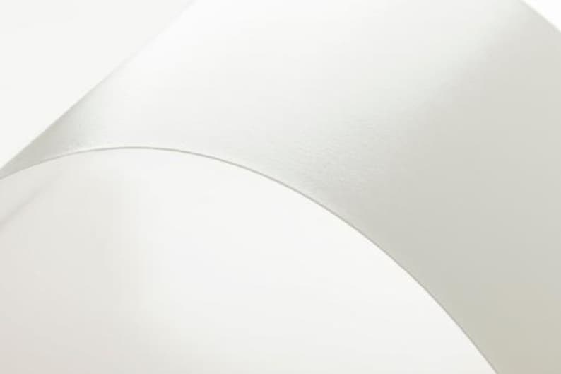 a close up of a white wall with a clock on it