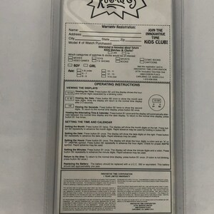 May include: Rugrats Kids Club watch warranty registration card. The card is white with blue and red text. It features a cartoon image of the Rugrats characters. The card includes instructions for setting the time and date on the watch.