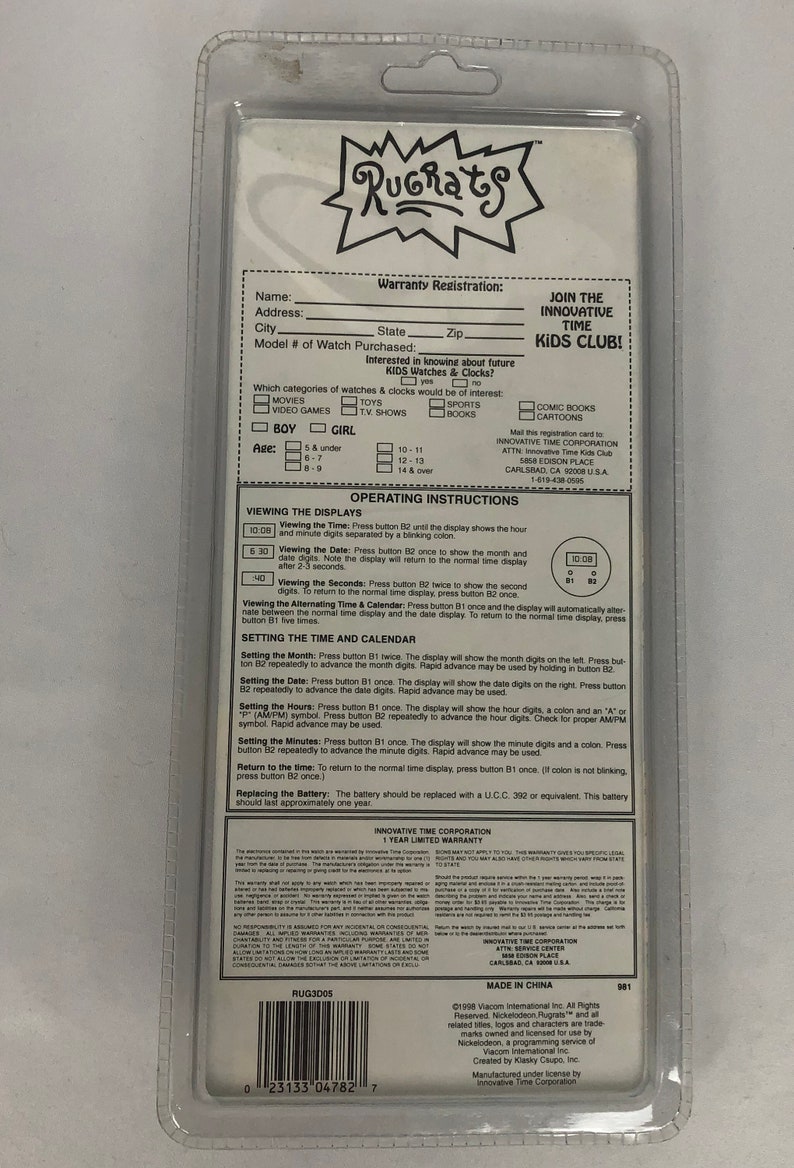 May include: Rugrats Kids Club watch warranty registration card. The card is white with blue and red text. It features a cartoon image of the Rugrats characters. The card includes instructions for setting the time and date on the watch.