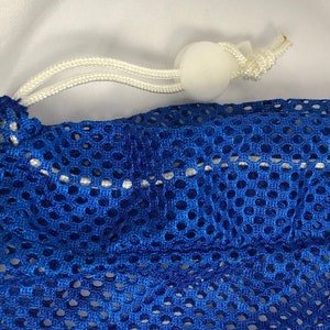 May include: A blue mesh laundry bag with a white drawstring and a white toggle.