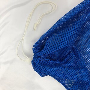 May include: A blue mesh laundry bag with a white drawstring.