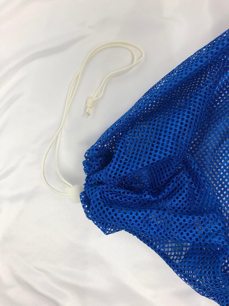 May include: A blue mesh laundry bag with a white drawstring.