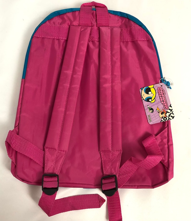 May include: Pink backpack with blue trim and adjustable straps. The backpack has a zippered pocket on the front and a tag with the words "Powerpuff Girls" on the side.