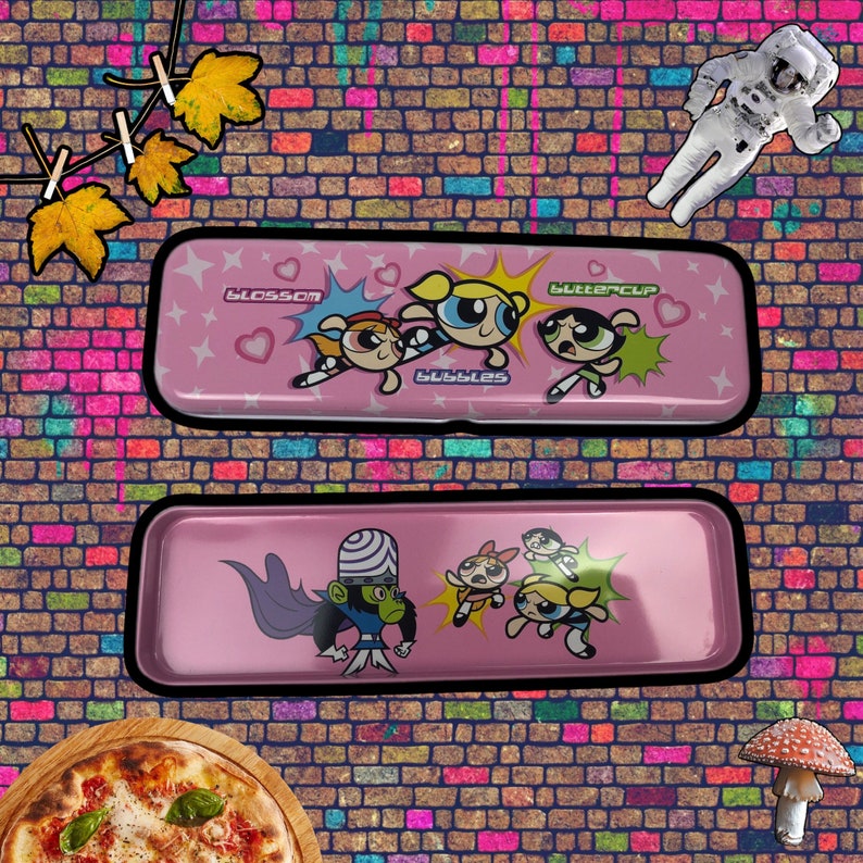 May include: Pink metal pencil case featuring the Powerpuff Girls characters Blossom, Bubbles, and Buttercup. The case also includes a graphic of Mojo Jojo, the girls' nemesis.