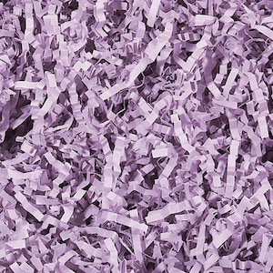 May include: A close-up of a pile of lavender-colored shredded paper. The paper is made of thin strips that are twisted and curled.