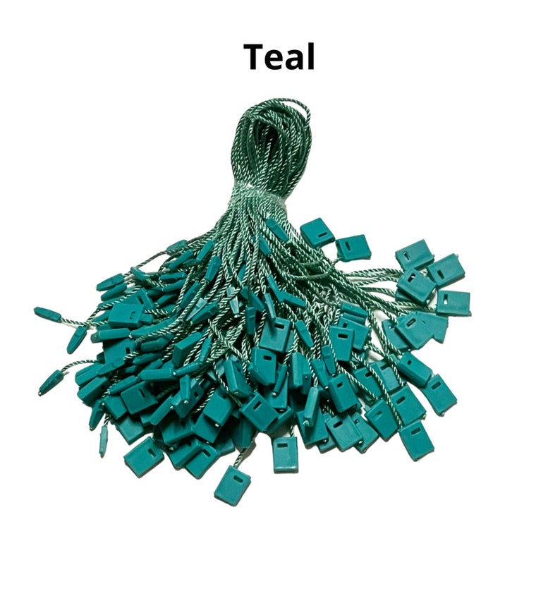 May include: Teal colored string with plastic tags attached. The string is twisted and the tags are piled on top of each other.