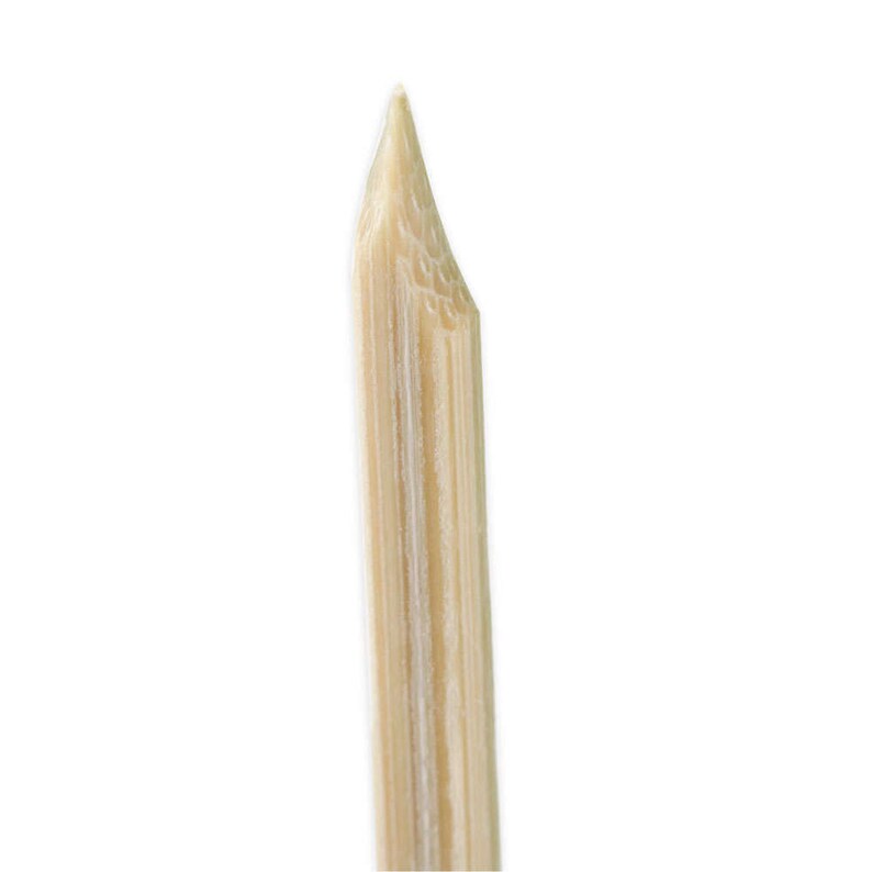May include: Close-up of the pointed tip of a natural wood skewer.