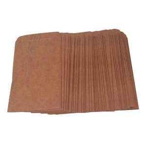 May include: A stack of brown paper bags, likely for packaging small items.