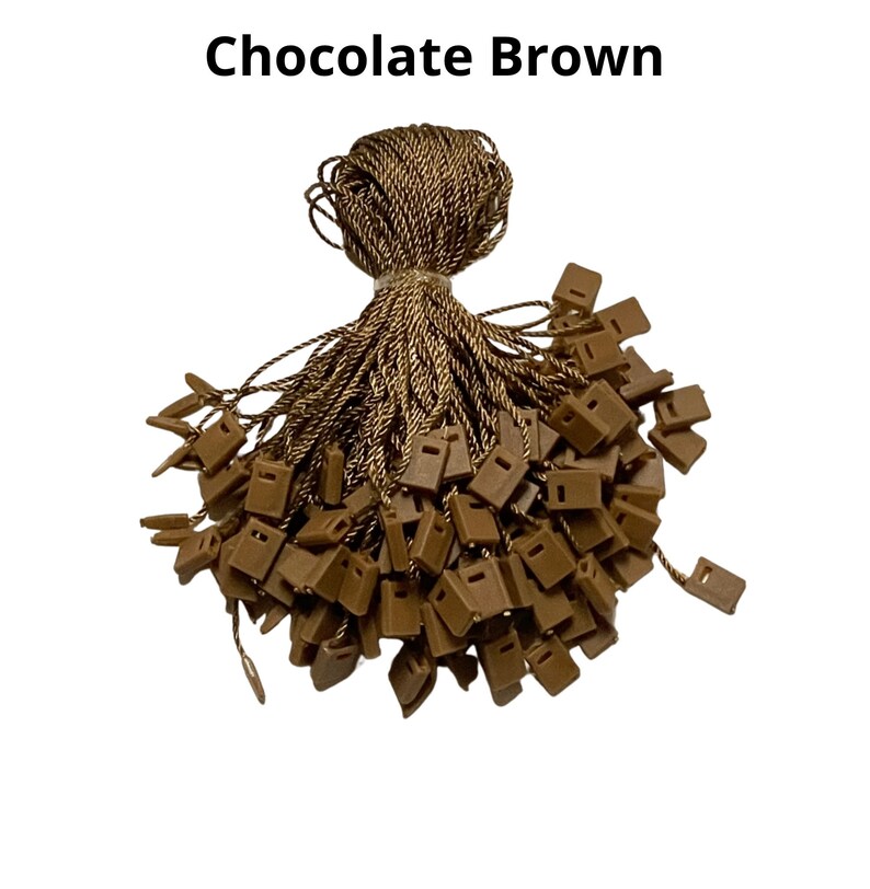 May include: A bundle of brown string with brown plastic tags attached. The string is twisted and the tags are piled on top of each other. The string is called "Chocolate Brown".