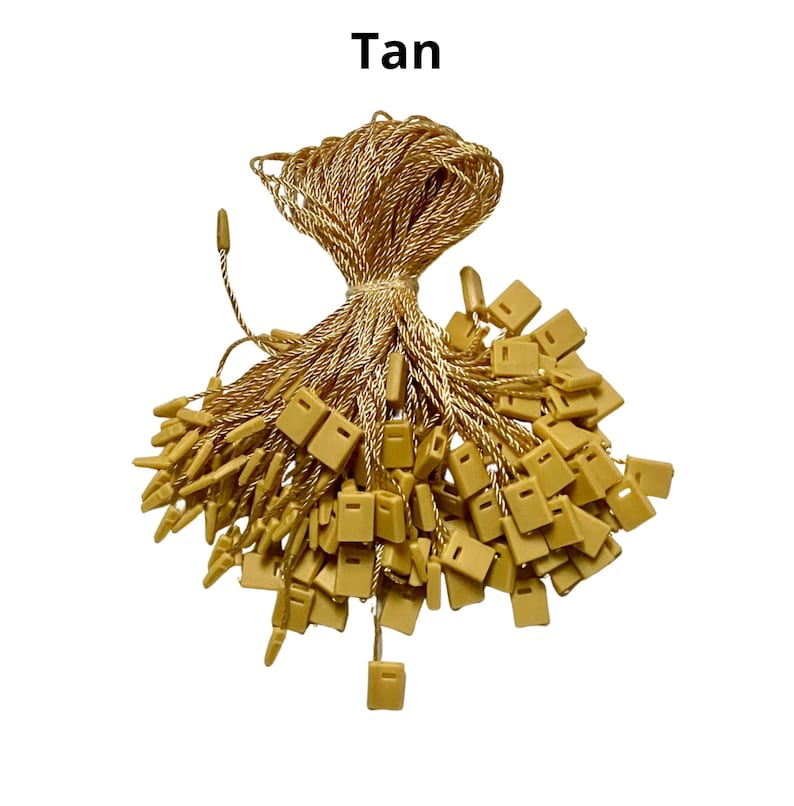 May include: A bundle of tan string with small, square plastic tags attached. The string is twisted and the tags are clustered together.