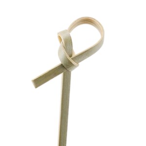 May include: A natural bamboo skewer with a knotted loop at the top. The skewer is light brown in color and is perfect for holding food together.