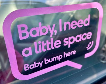 May include: Pink car window sticker with the text "Baby, I need a little space" and "Baby bump here" in a speech bubble.