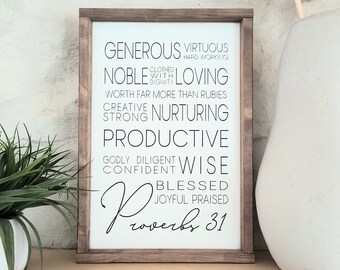 May include: A wooden sign with a white background and black text. The text reads "Generous Virtuous Hard Working Noble Loving Clothed With Dignity Worth Far More Than Rubies Creative Nurturing Strong Productive Godly Diligent Confident Wise Blessed Joyful Praised Proverbs 31".