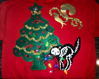 ugly christmas sweater front and back lighted cat chewing on christmas lights thus fried cat on the back, flying squirrel  into the tree