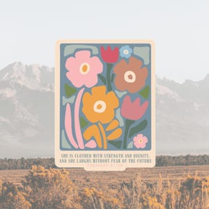 May include: A floral art print featuring stylized flowers in pink, orange, brown, and red against a blue background. The print includes the text: "SHE IS CLOTHED WITH STRENGTH AND DIGNITY, AND SHE LAUGHS WITHOUT FEAR OF THE FUTURE."