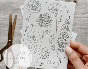 May include: A sheet of printable stickers featuring black line drawings of various flowers and leaves. The text "JULY - DECEMBER SET 1" is printed in a circle at the bottom of the sheet.