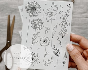 May include: A sheet of black and white floral illustrations with the text "JULY - DECEMBER SET 2". The illustrations include a sunflower, a daisy, a lily, a moon, and various leaves.