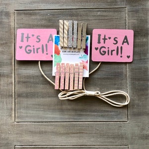 baby girl shower onesie clothesline display, pink and silver, baby girl clothes display for a baby shower, baby shower decoration