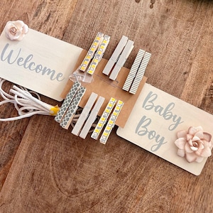 baby boy shower onesie clothesline display, baby boy clothes display for a baby shower, baby shower decoration