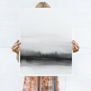 May include: A black and white watercolor print of a landscape with a hazy, abstract horizon. The print is on a white background and is framed with a thin white border.