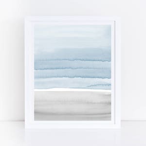 May include: A framed watercolor painting with a blue and gray color scheme. The painting features a series of horizontal lines in shades of blue, with a gray band at the bottom.