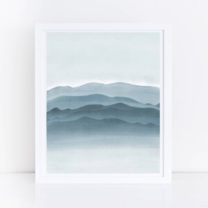 May include: A watercolor painting of a blue mountain range with a light blue sky in the background.