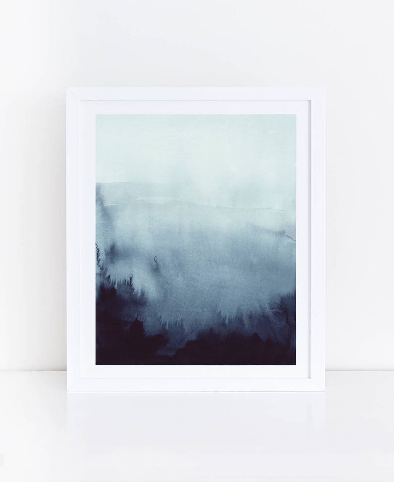 May include: A framed watercolor painting of a blue and gray landscape with a hazy, foggy atmosphere. The painting features a gradient of blue and gray colors, creating a sense of depth and distance.