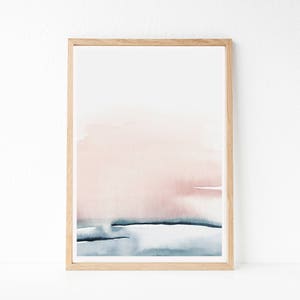 May include: A framed abstract watercolor painting with a pink and blue color scheme. The painting features a soft, blended transition from a light pink to a darker blue, creating a sense of depth and movement. The painting is framed in a simple, natural wood frame.
