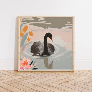 May include: A framed illustration of a black swan swimming in a blue and pink lake with orange and pink flowers. The swan has a black body and a red beak.