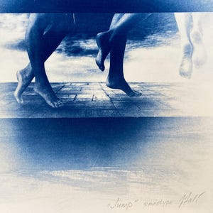 May include: A cyanotype photograph of two pairs of feet, one pair walking on a wooden surface and the other pair suspended in mid-air. The background is a cloudy sky. The image is titled "Jump" and signed "Hall".