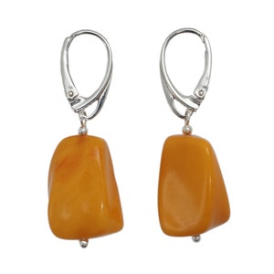 Tiny Bell Amber Earrings is handmade from Natural Baltic Amber. The amber stone color is Dark Yellow, Shining
