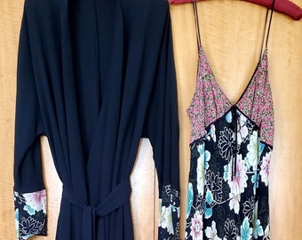 May include: A black robe with floral print trim and a matching floral print slip dress.