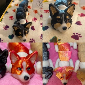May include: A collection of 3D printed figurines of corgis in various poses. The figurines are painted in black, white, and orange.