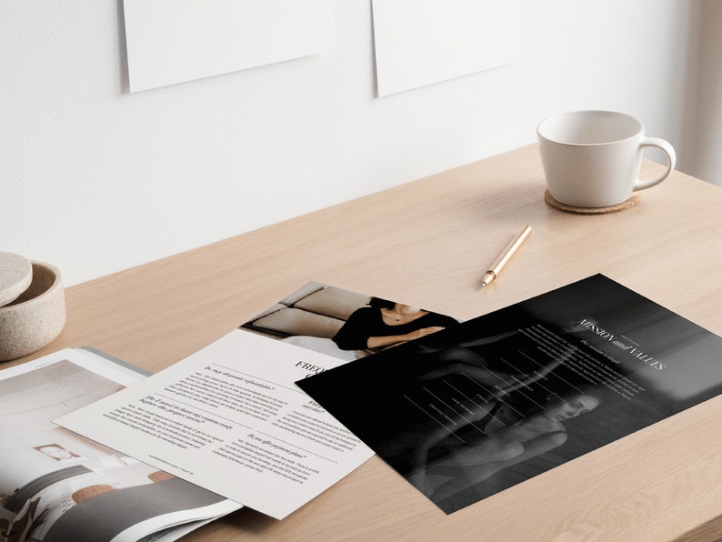 May include: A black and white photo of a woman sitting on a couch. The photo is part of a brochure with the text "Mission and Values" printed on it. The brochure is on a wooden table with a white coffee mug and a pen.