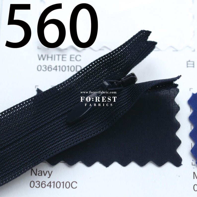 May include: A close-up of a black zipper with a matching pull tab. The image includes the text "560", "WHITE EC", "Navy", and "FO:REST FABRICS". The zipper is set against a white and navy blue background.
