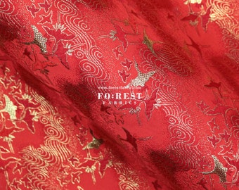 May include: Red fabric with a gold brocade pattern of birds and clouds. The fabric has a subtle sheen and a luxurious feel. The text "FOREST FABRICS" is visible in the lower centre of the image.