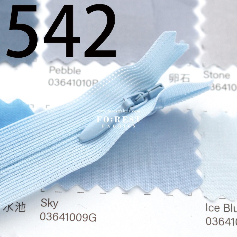 May include: A light blue zipper with a matching pull tab is shown against a backdrop of fabric swatches. The number "542" is prominently displayed at the top. The fabric swatches are labeled with color names and codes.