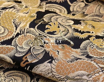 May include: Black fabric with a gold and brown dragon pattern. The fabric is woven with a raised texture, giving it a three-dimensional look. The fabric is called "FOREST FABRICS".