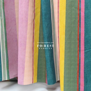 May include: A close-up of a fabric with vertical stripes in a variety of colours, including pink, green, yellow, and teal. The fabric has stripes of different widths. The text "www.forestfabric.com" and "FO:REST FABRICS" is visible.