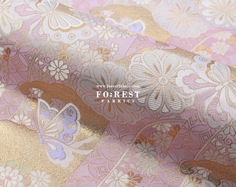 May include: Pink and gold brocade fabric featuring a floral and butterfly design. The fabric is woven with a raised texture and has a subtle sheen. The fabric is sold by the metre and is ideal for crafting, quilting, and home decor projects. www.forestfabric.com FOREST FABRICS