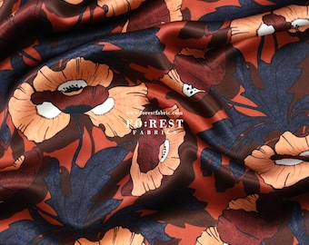 May include: A close-up of a red, orange, and blue floral fabric with a satin finish. The fabric features a repeating pattern of large poppy flowers with white centers. The fabric is from Forest Fabrics.