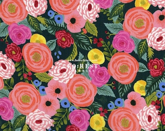 May include: A dark blue fabric with a floral pattern featuring pink, red, yellow, and blue flowers. The fabric has a vintage, hand-painted look.