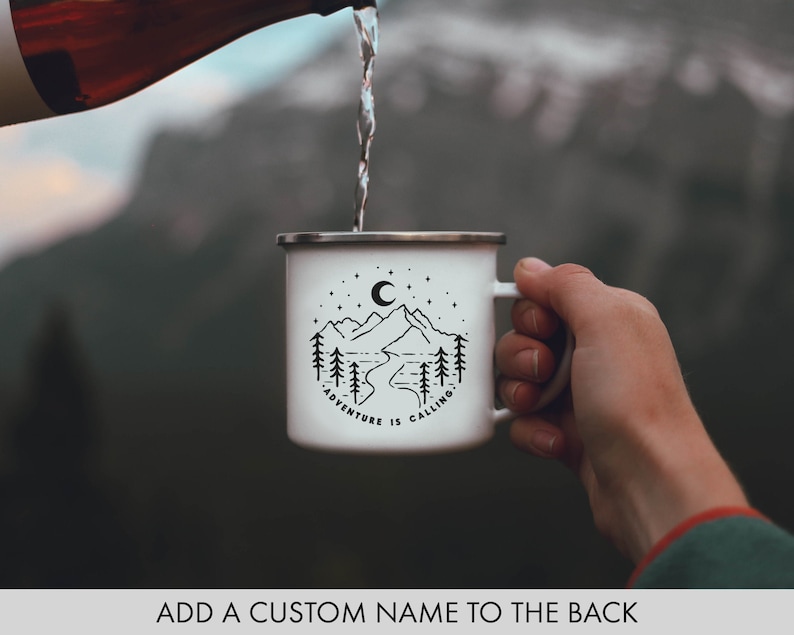 May include: White enamel camping mug with a black mountain scene and the text "Adventure is Calling".