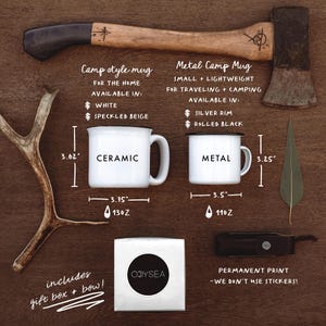 May include: Two camping mugs, one ceramic and one metal, with measurements and capacity listed. The ceramic mug is white with black text that says "CERAMIC". The metal mug is white with black text that says "METAL". Both mugs are on a wooden background with a small axe and antlers.