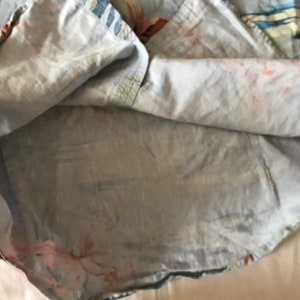 May include: A light blue cotton shirt with a floral print. The shirt is turned inside out, showing the lining.