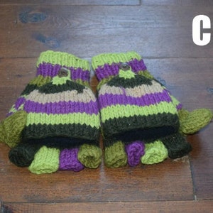 May include: A pair of knitted fingerless gloves with a striped pattern in green, purple, brown, and beige. The gloves have a button detail on the top.